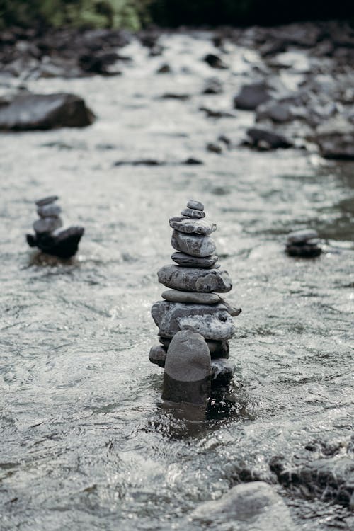 Free Stack of zen rocks in streaming water of river Stock Photo