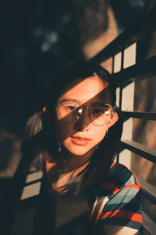 Portrait of a Pretty Girl with Eyeglasses Looking at the Camera
