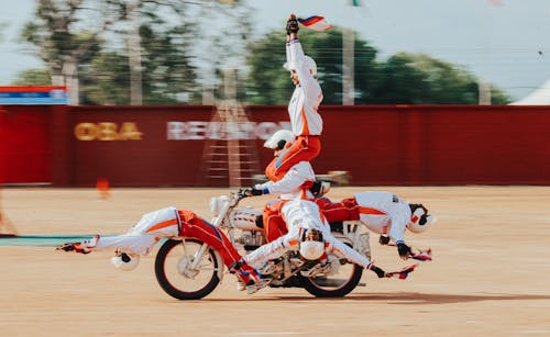 Performers riding on a Motor doing Dangerous Stunt 