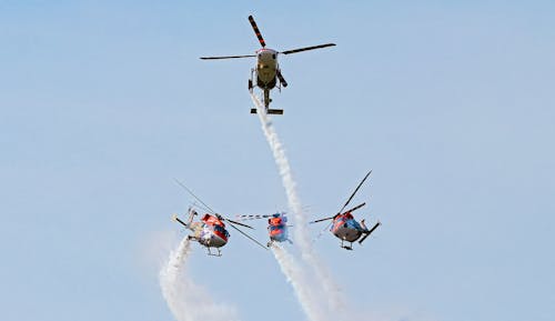 Red and White Helicopter Flying in the Sky