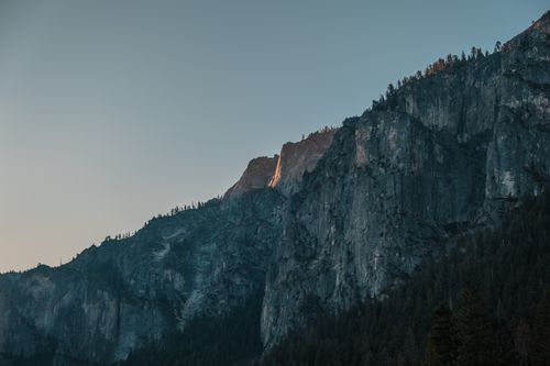 Free Dramatic view of Yosemite Valley cliffs illuminated by sunrise light, showcasing natural beauty. Stock Photo