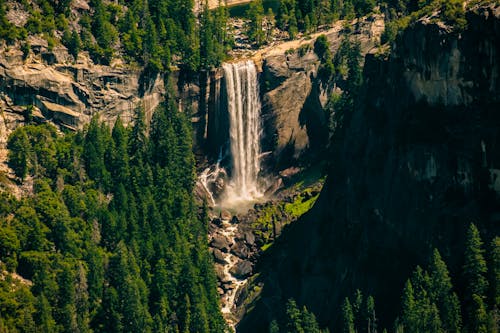 Waterfalls on Rock Mountain Near Green Trees