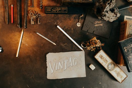 A flatlay showcasing vintage and antique stationery items on a rustic table.
