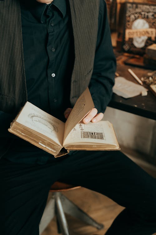 Man in Gray Suit Jacket Reading Book