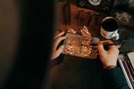 Person Holding Brown and White Ceramic Mug
