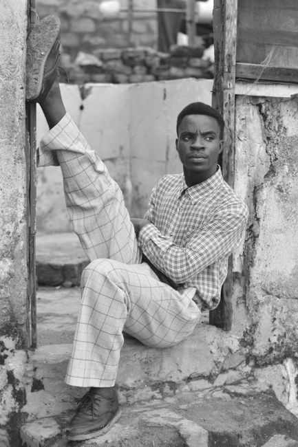 Monochrome portrait of a fashionable man posing in vintage style.