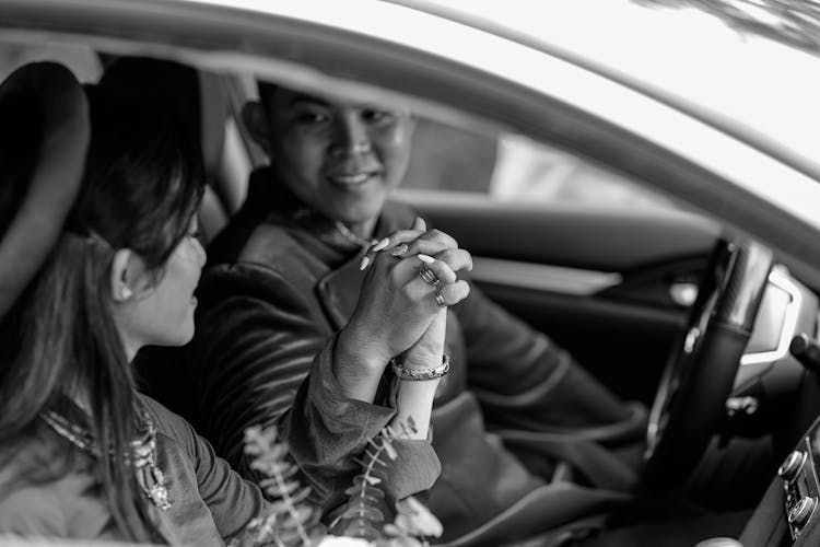 Newly Married Couple Sitting In Car