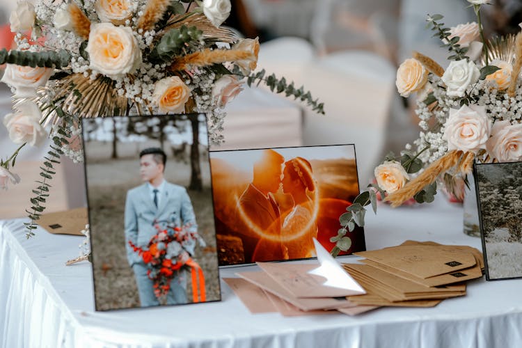 Decorated Wedding Table With Flowers And Photos