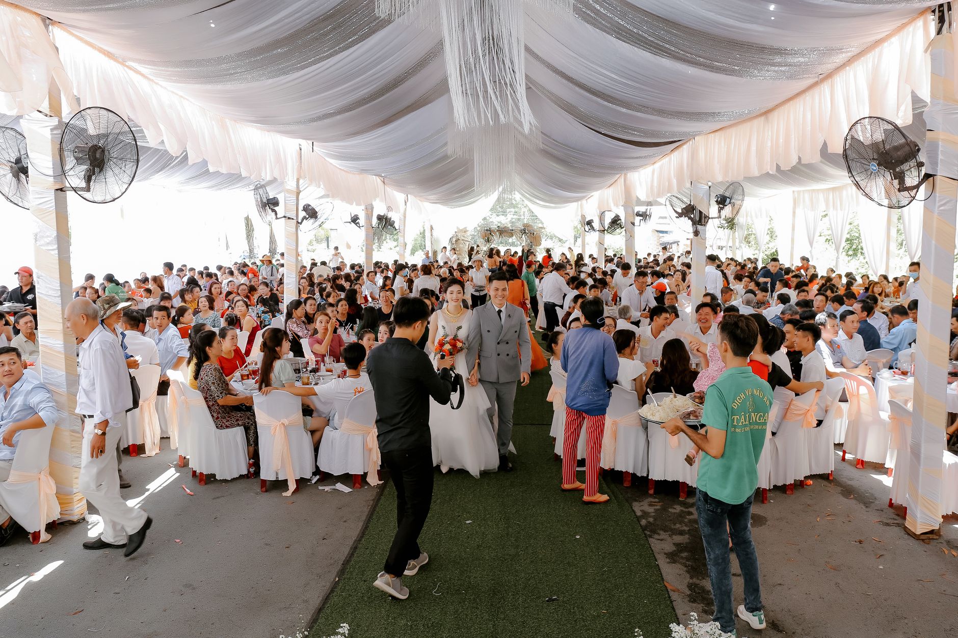 How to Build a Wedding Do-Not-Play List That Works Wedding guests celebrating together in a decorated reception space