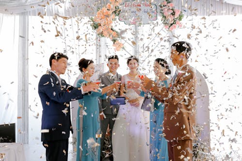 Free Happy newlyweds with guests on wedding celebration Stock Photo