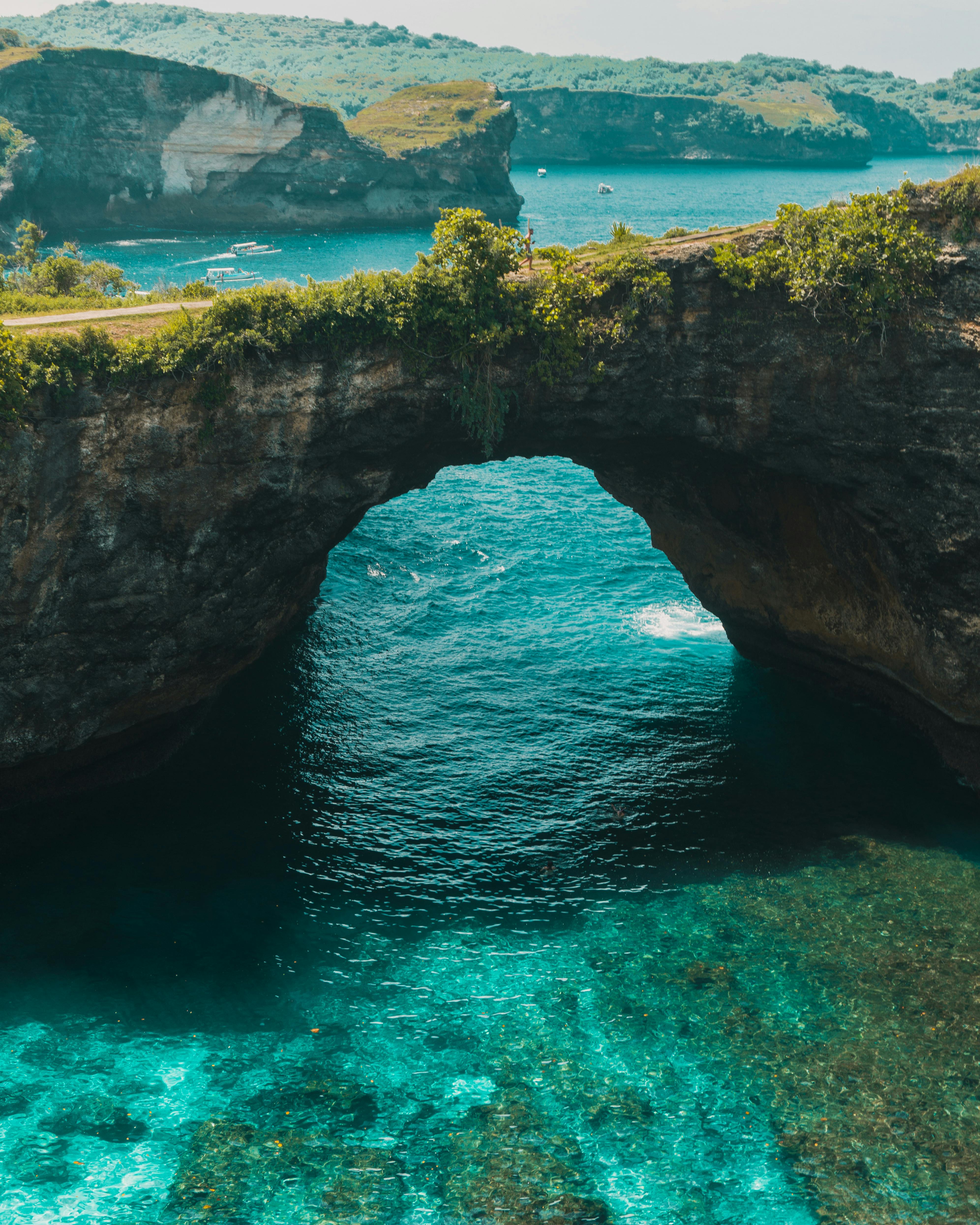 Broken Beach natural rock arch framing turquoise sea water inside the cove on Nusa Penida west coast Bali