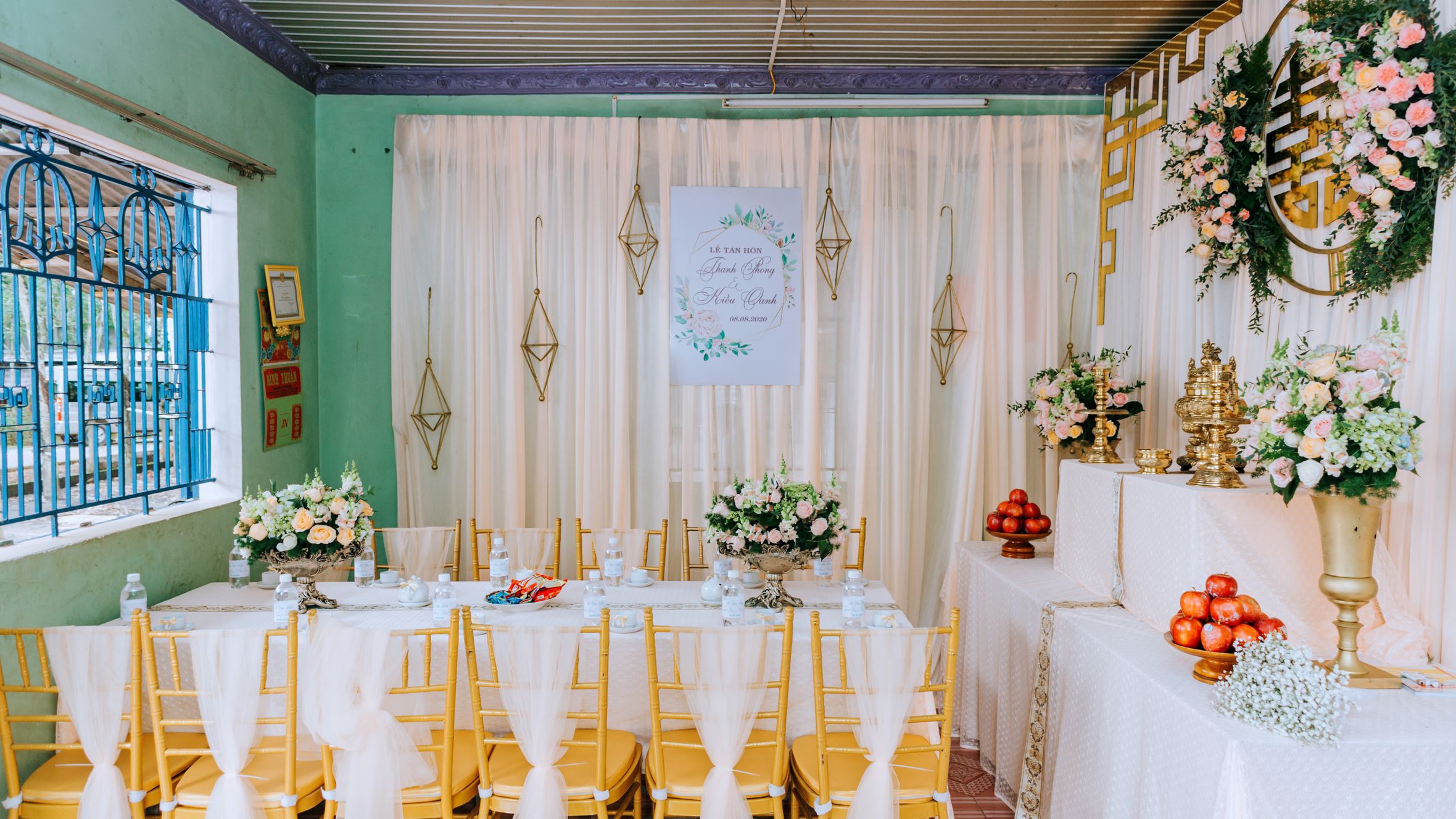 Decorated room with banquet table and huge number of flowers for wedding celebration in daylight