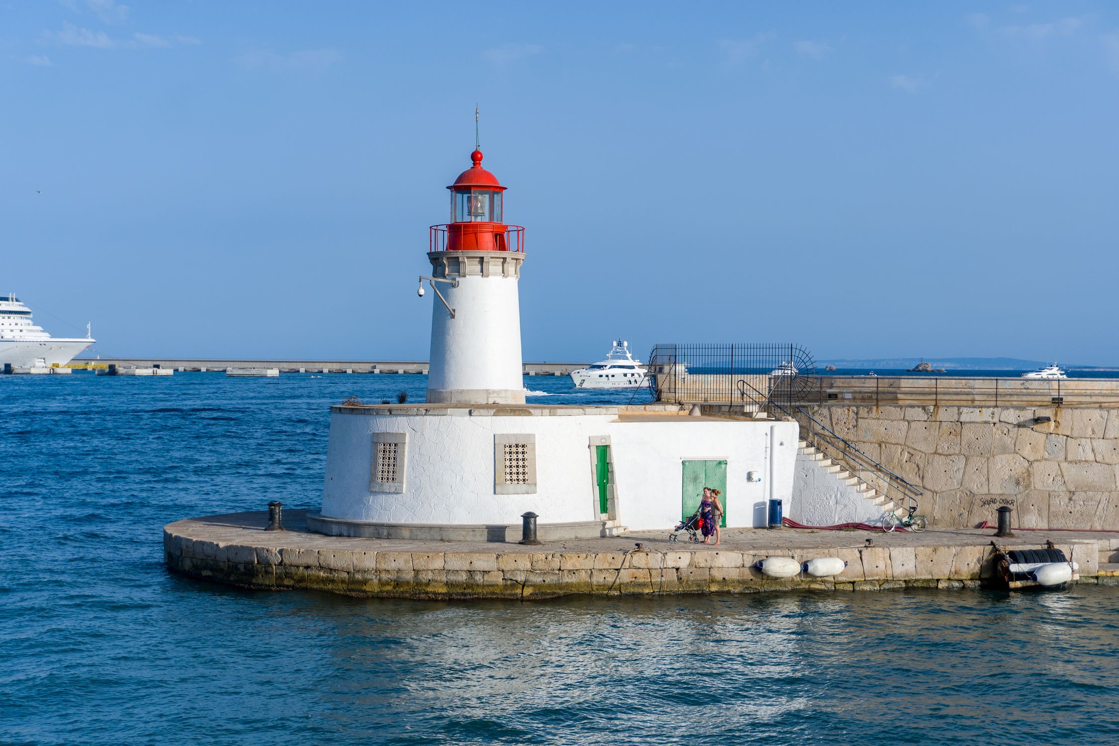 White and Red Lighthouse Near Body of Water under Blue Sky · Free Stock ...