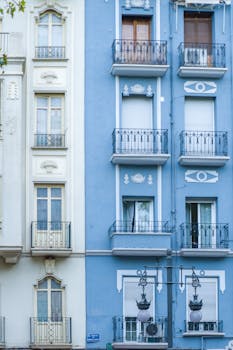 Elegant facade of residential buildings in Valencia showcasing unique design elements.