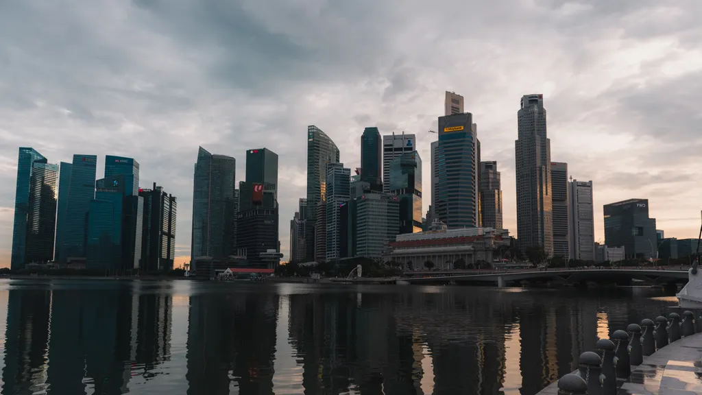 Singapore skyline reflecting on the waterfront at dusk