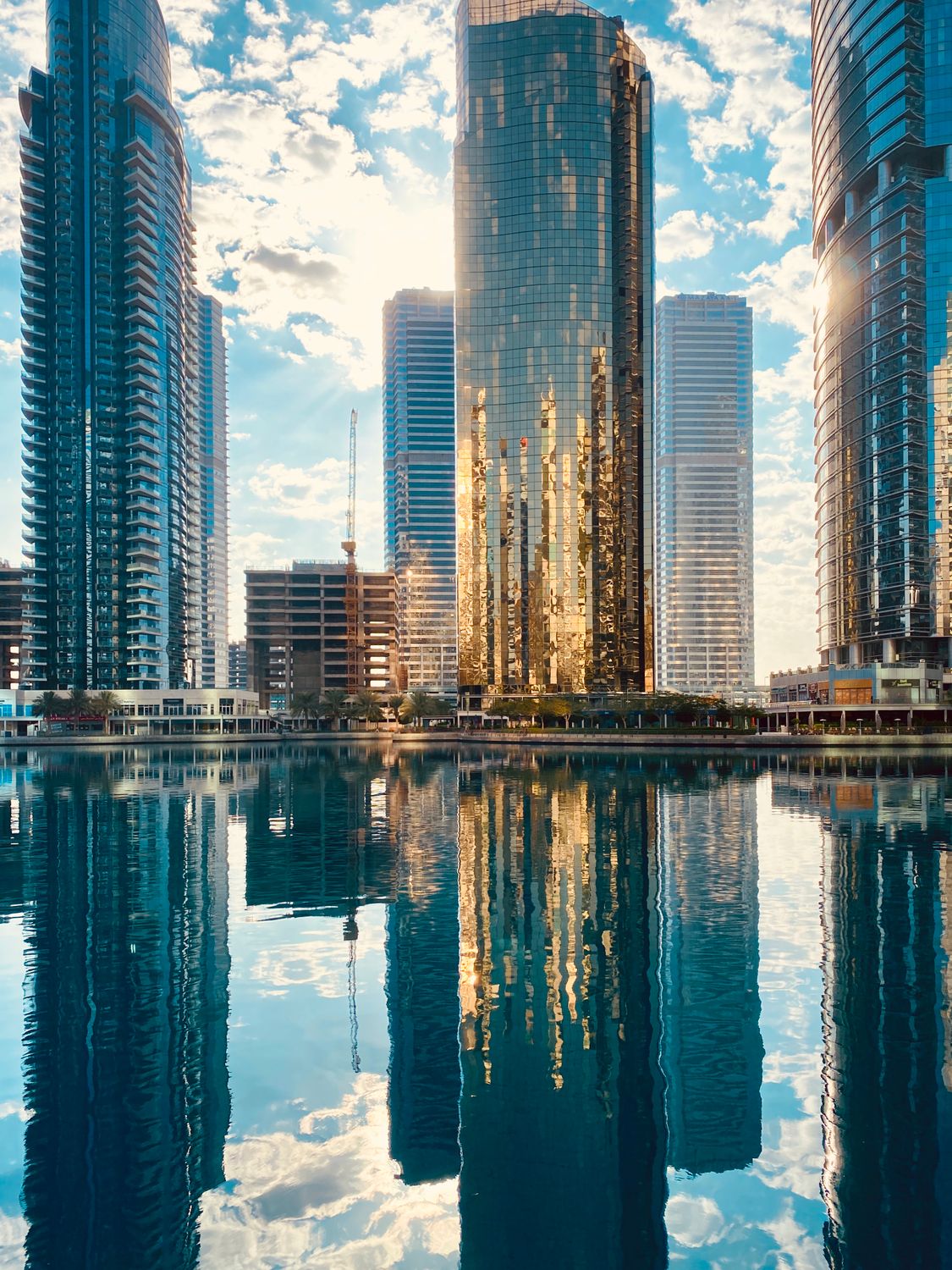 Modern City Examples Modern city district with skyscrapers reflecting in pond · Free Stock Photo