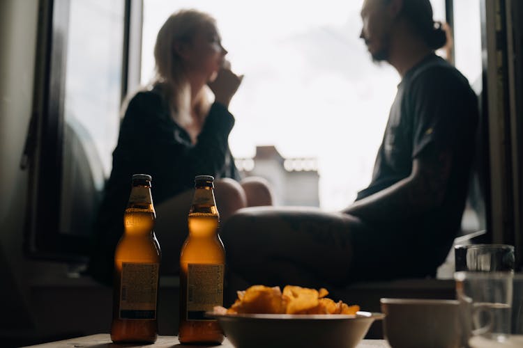 Beer Bottles And A Bowl Of Chips