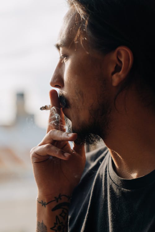 Side View of a Man Smoking a Cigarette