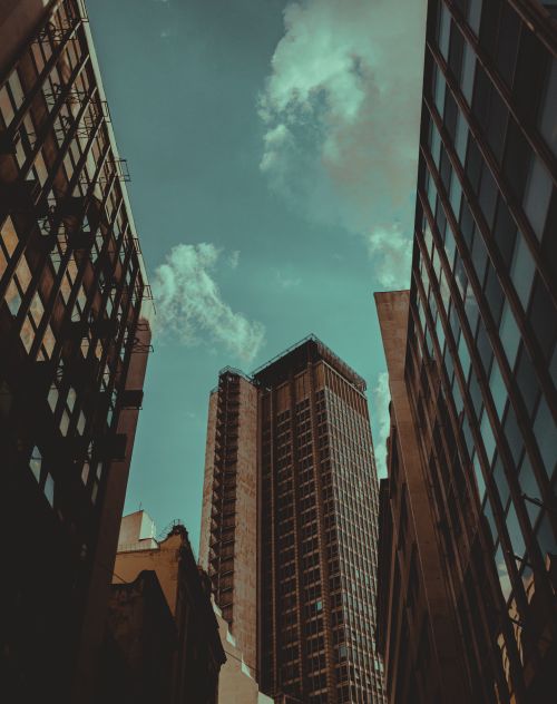 Free Low angle view of modern skyscrapers in an urban setting with a dramatic sky. Stock Photo