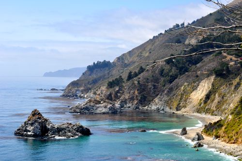 Free Stunning view of California's rugged coastline with clear blue waters and rocky cliffs. Stock Photo