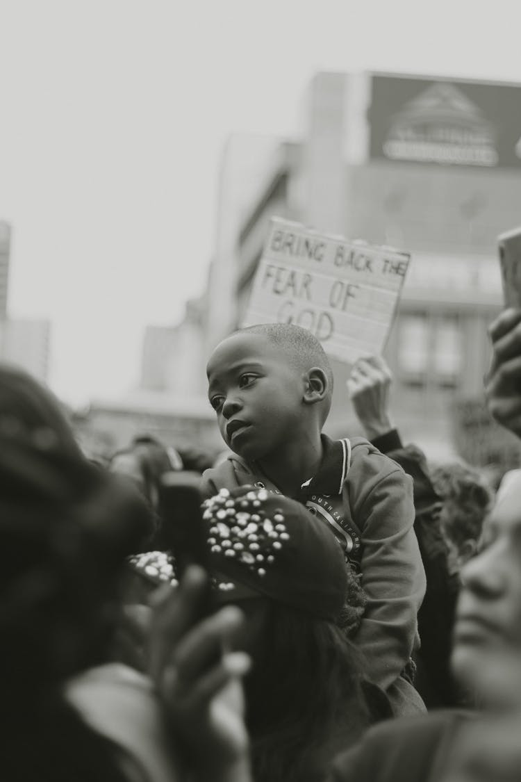 Black Child On Protest On Street