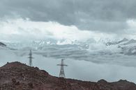 Snowy mountains behind clouds and mounts
