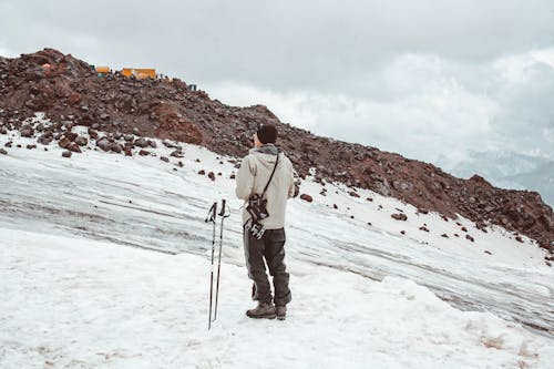 Free Male traveler on snowy mountain slope Stock Photo