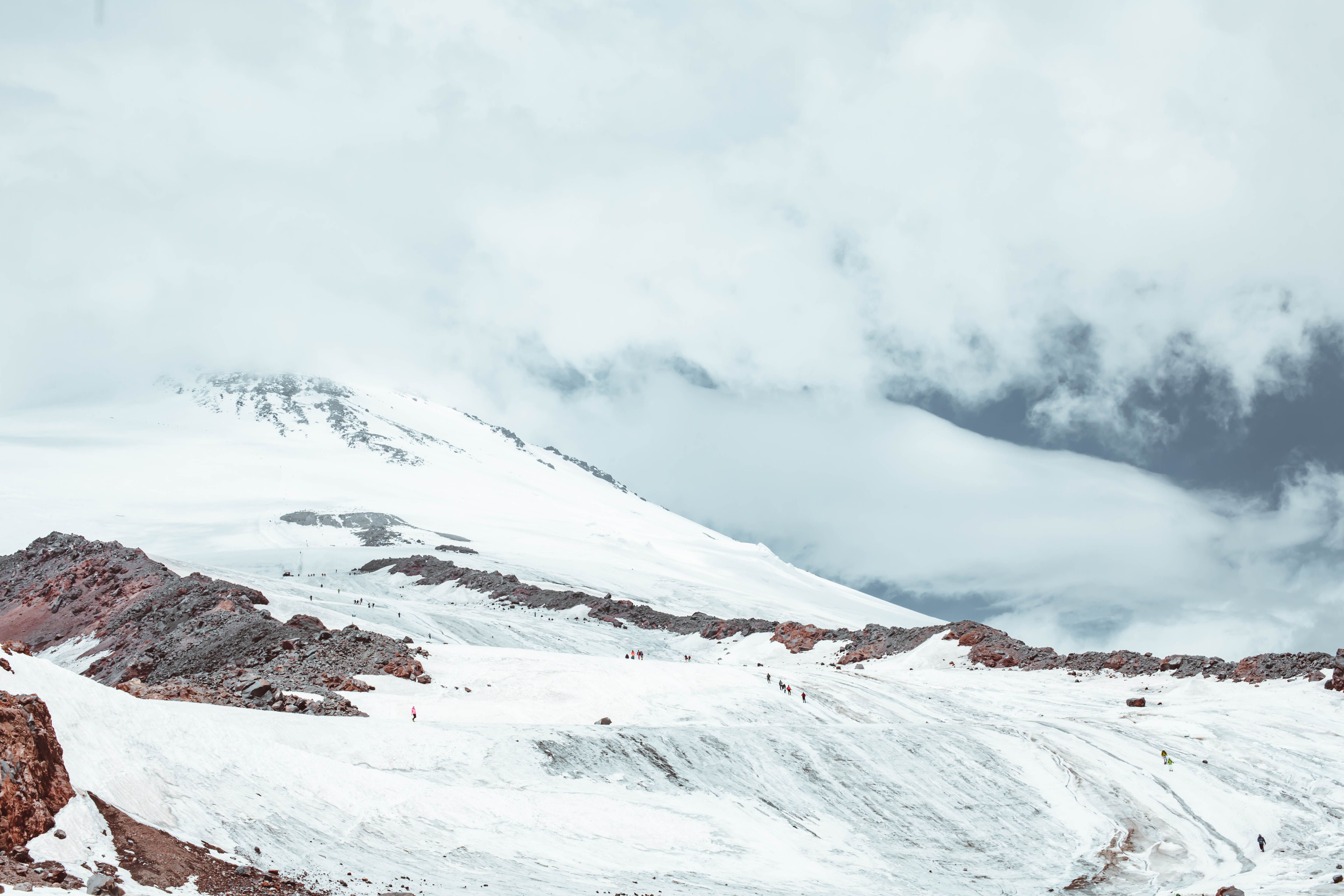 Picturesque view of snowy mountain peak with icy slope on height in daylight