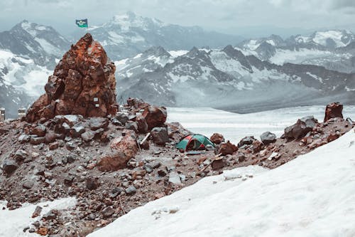 Mountain peak with snow and tent