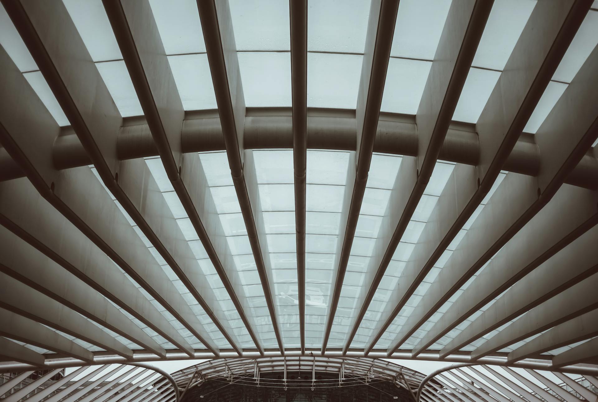 A low angle view of a modern architectural roof with glass and metal elements.