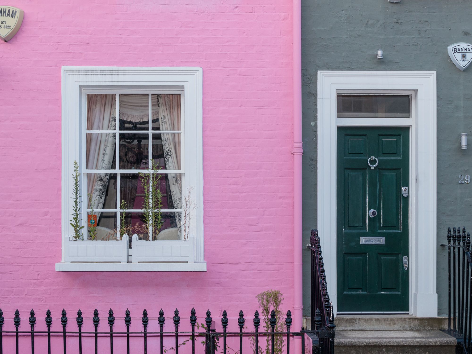 Exterior Painting in Cambridge Heath, Tower Hamlets — painter refreshing a house exterior in weatherproof paint
