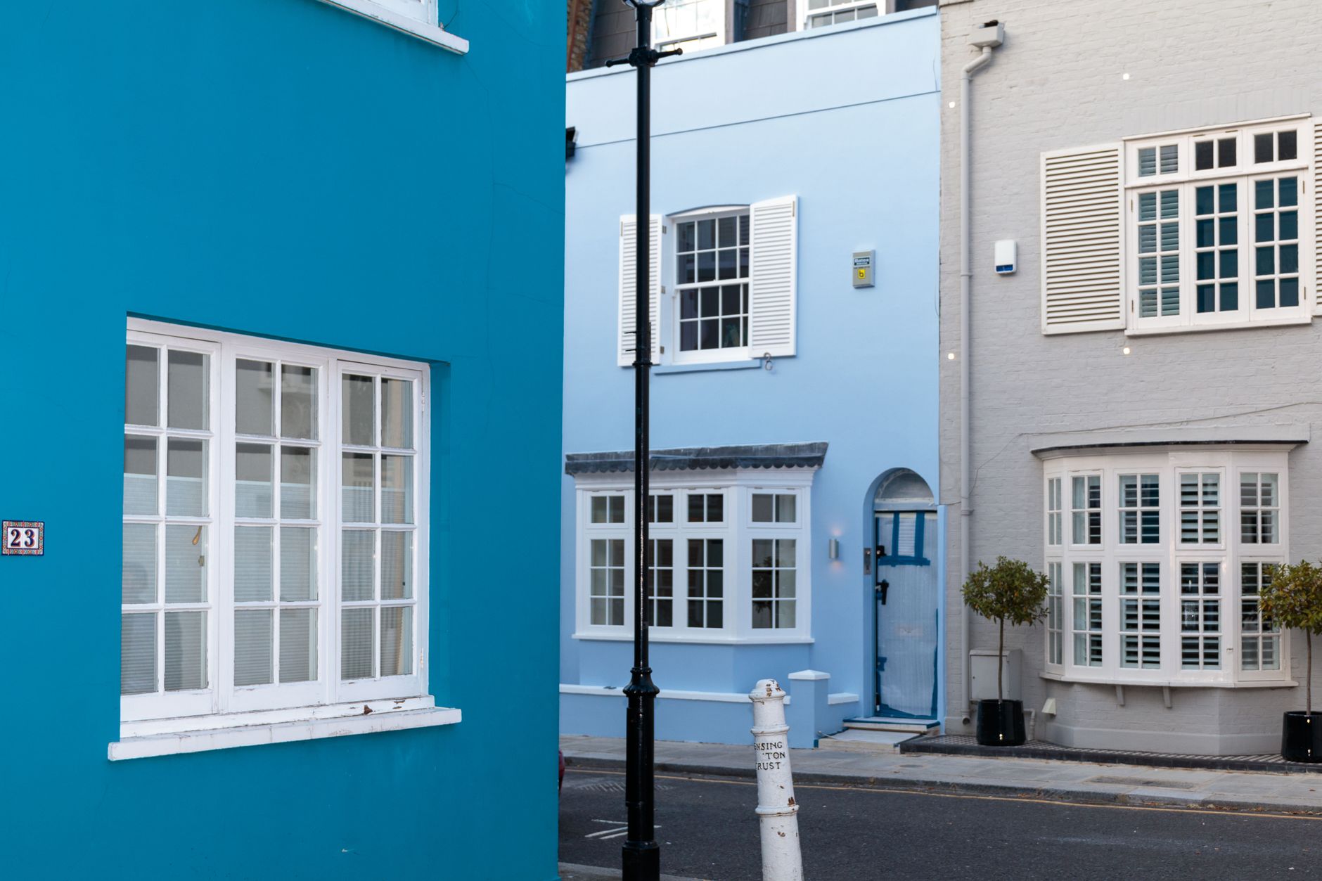Exterior of district with colorful residential houses with big windows with shutters at daytime