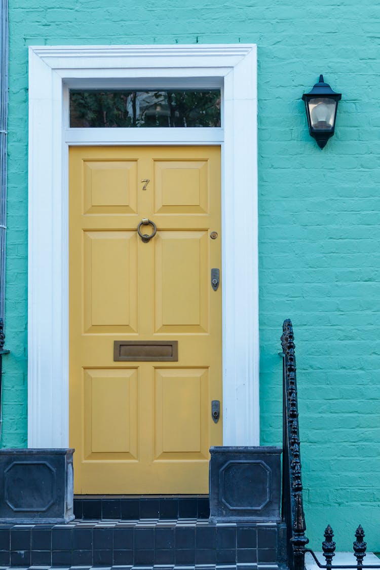 Exterior Of Brick Building With Yellow Door