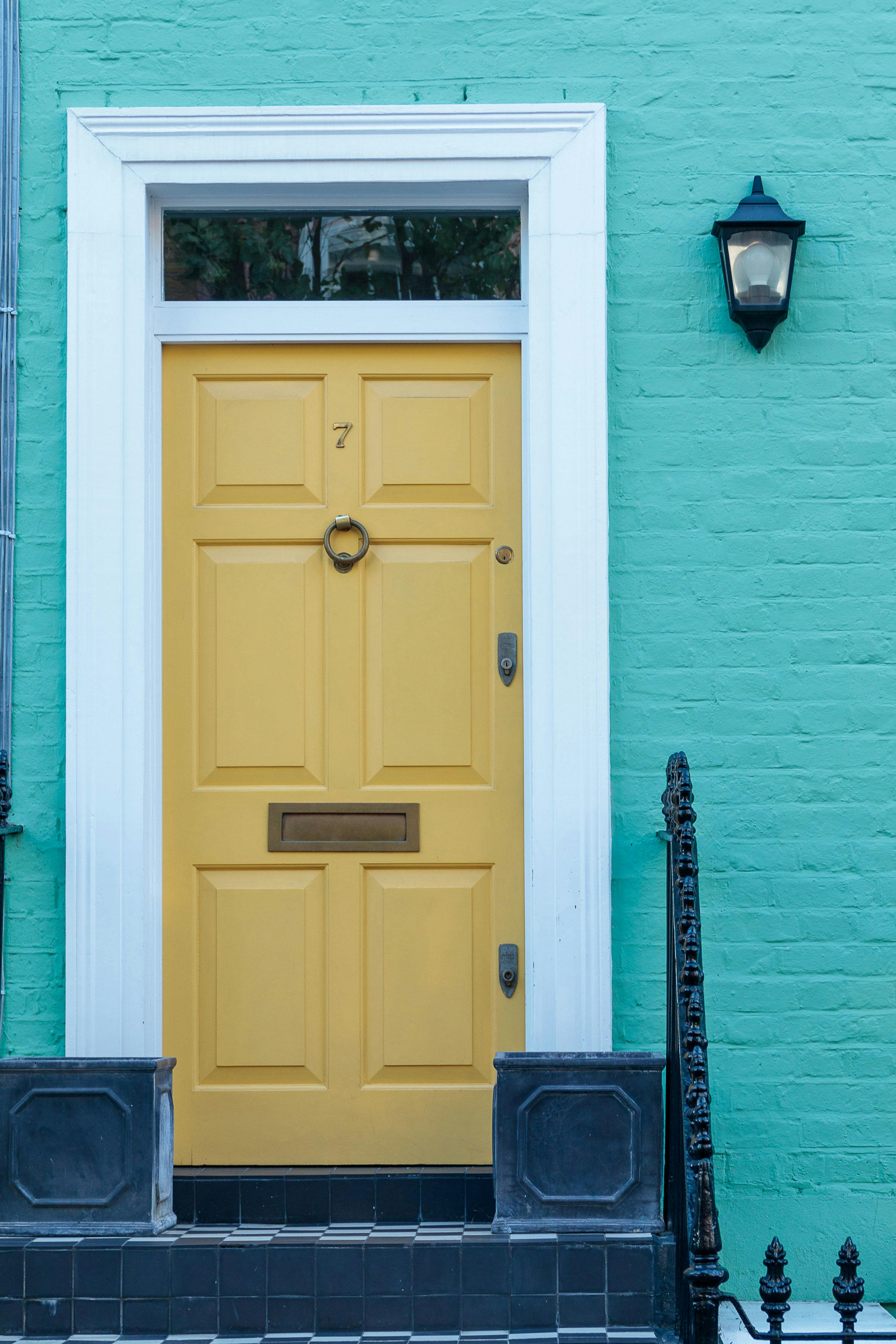 Exterior of brick building with yellow door · Free Stock Photo
