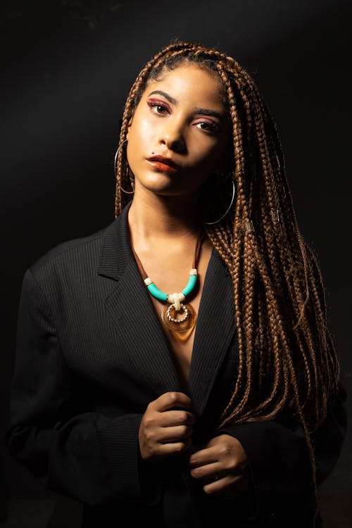 Attractive woman with dreadlocks in studio light