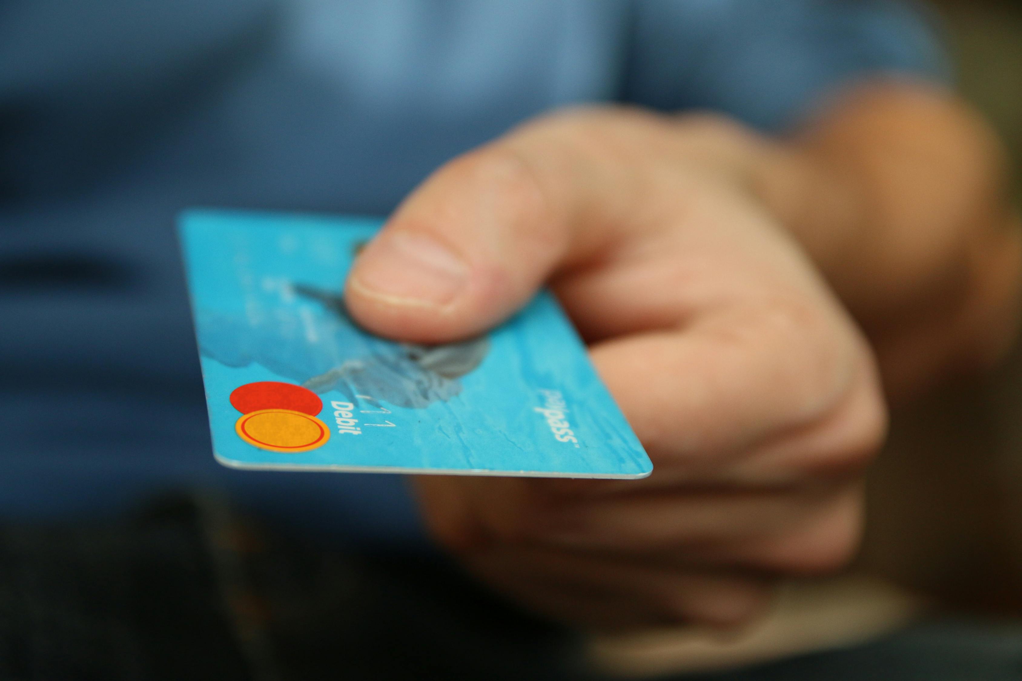 Close up photo of person holding bank card. 