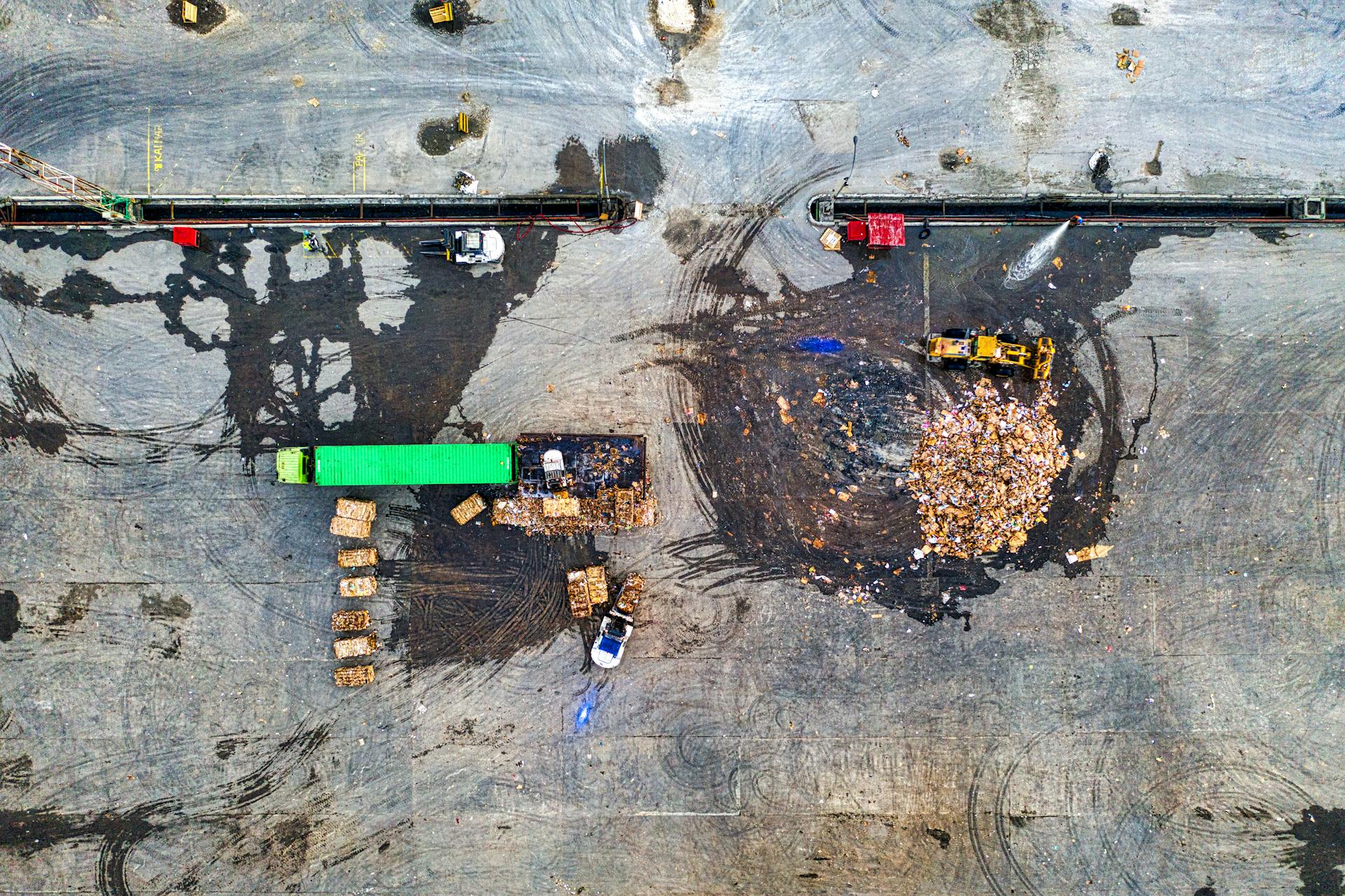 Heavy Equipment and a Truck Cleaning Up Garbage