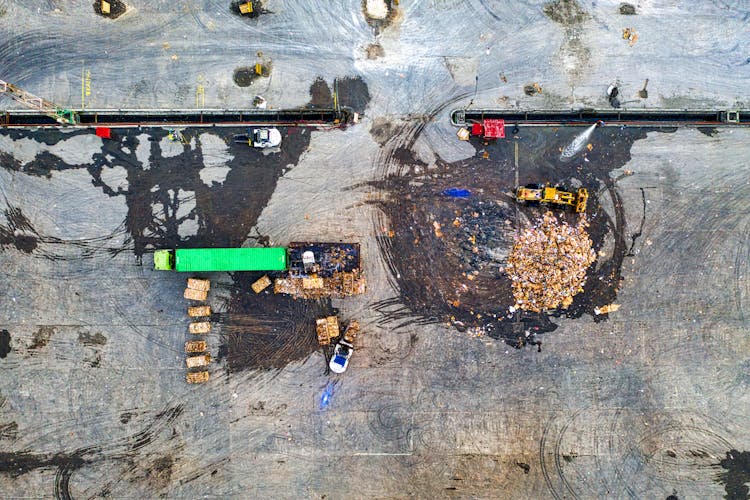 Heavy Equipment And A Truck Cleaning Up Garbage