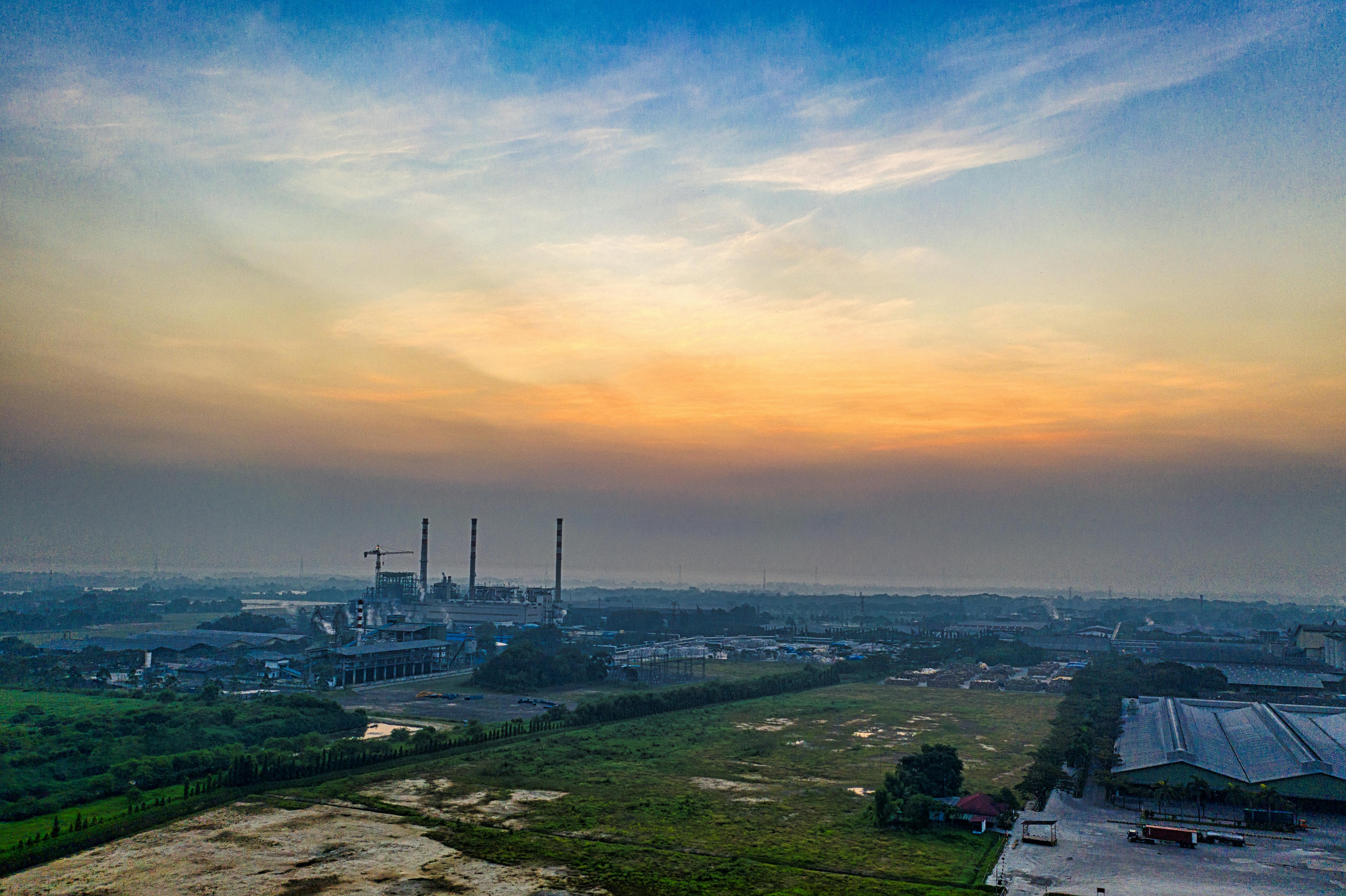 Aerial view of an industrial plant in Serang, Indonesia, at dawn with vibrant sky.
