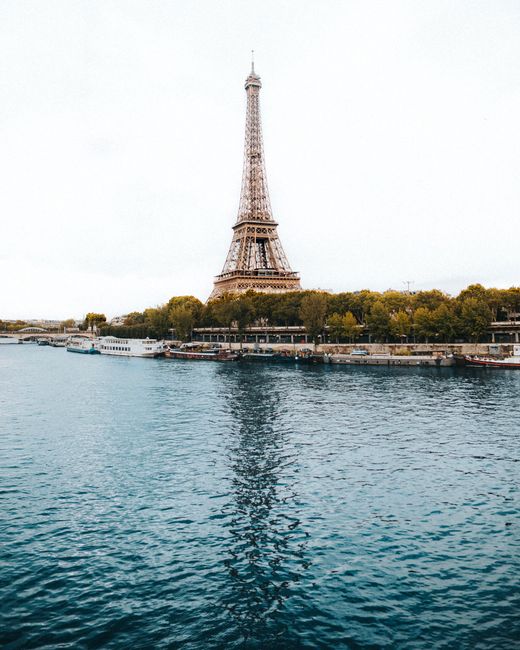 Eiffel Tower overlooking the Seine River in Paris, a symbol of France's heritage and elegance.