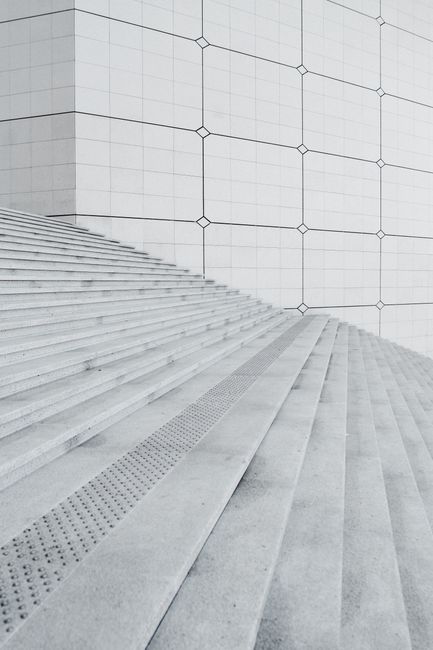 Geometric patterns on concrete stairs and wall showcasing minimalism.