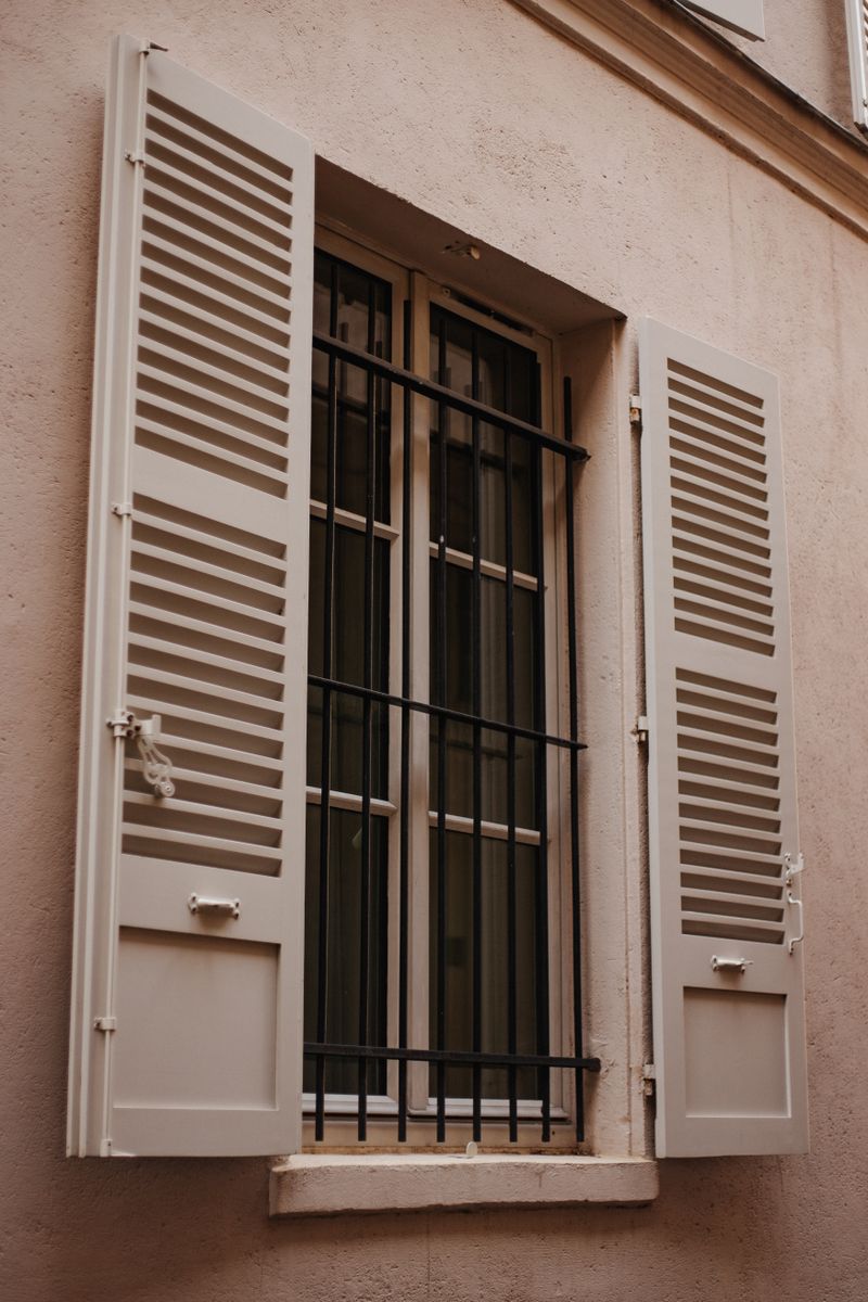 Window with wooden louver shutters