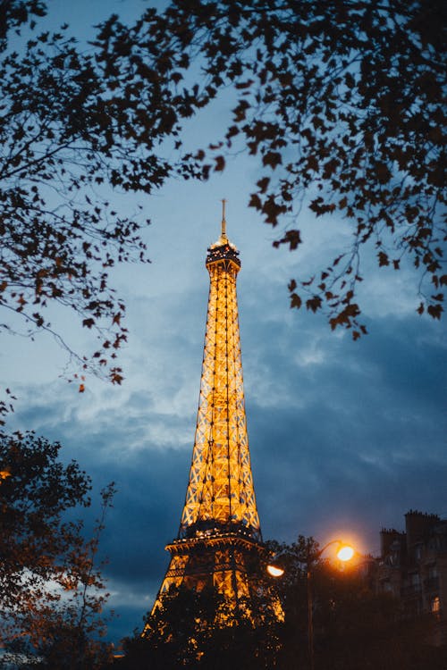Eiffel Tower Under Cloudy Sky during Night Time