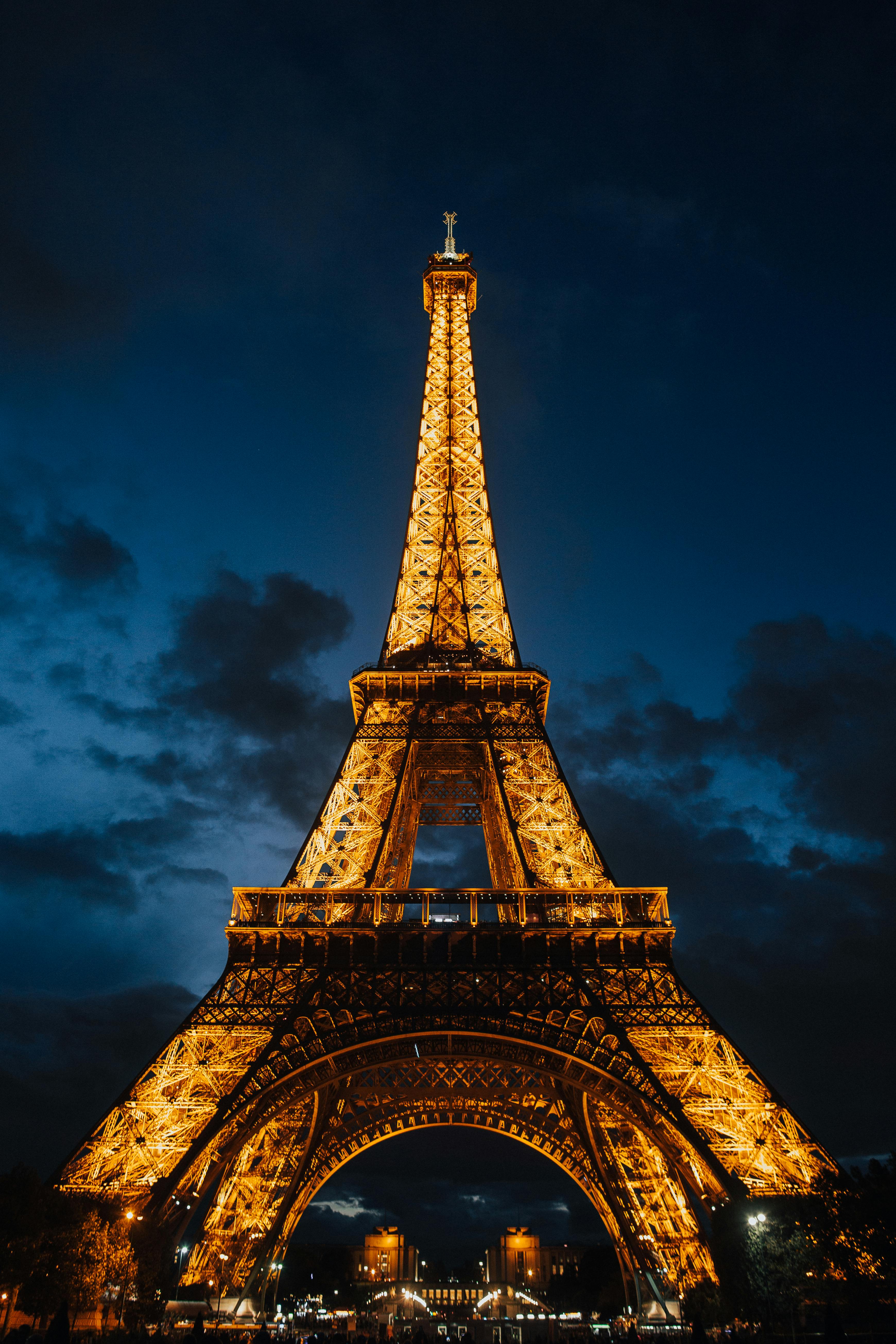 Low Angle Shot Of The Eiffel Tower With Illuminated Light At Night ...