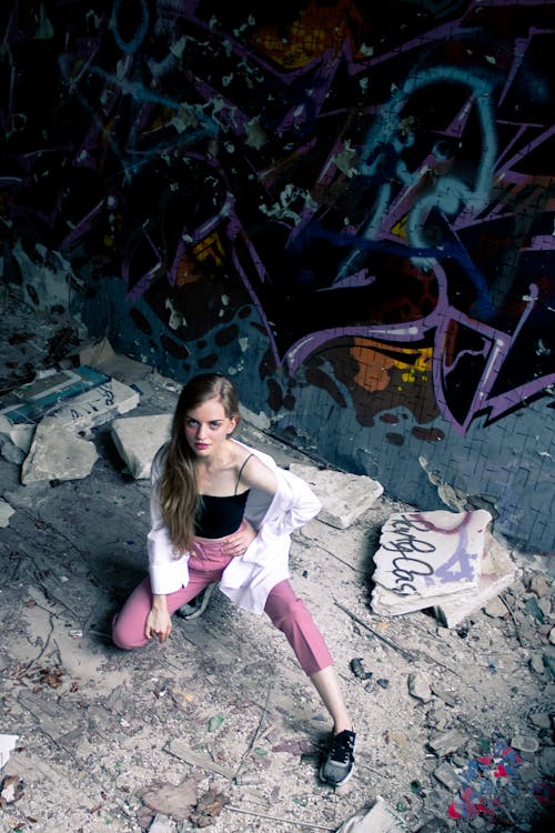 A Woman Posing in Front of a Graffiti Wall