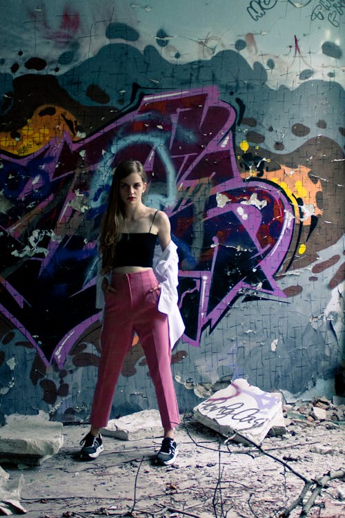 A Woman Posing in Front of a Graffiti Wall