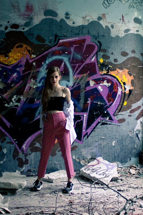 A Woman Posing in Front of a Graffiti Wall · Free Stock Photo