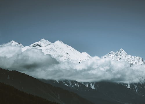 Snowy mountain peaks covered with clouds