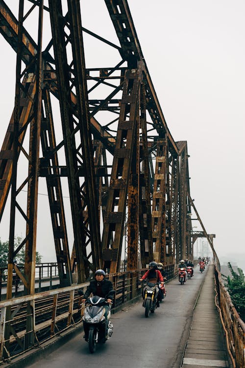 Free People on Motorcycles at Long Bien Bridge Stock Photo
