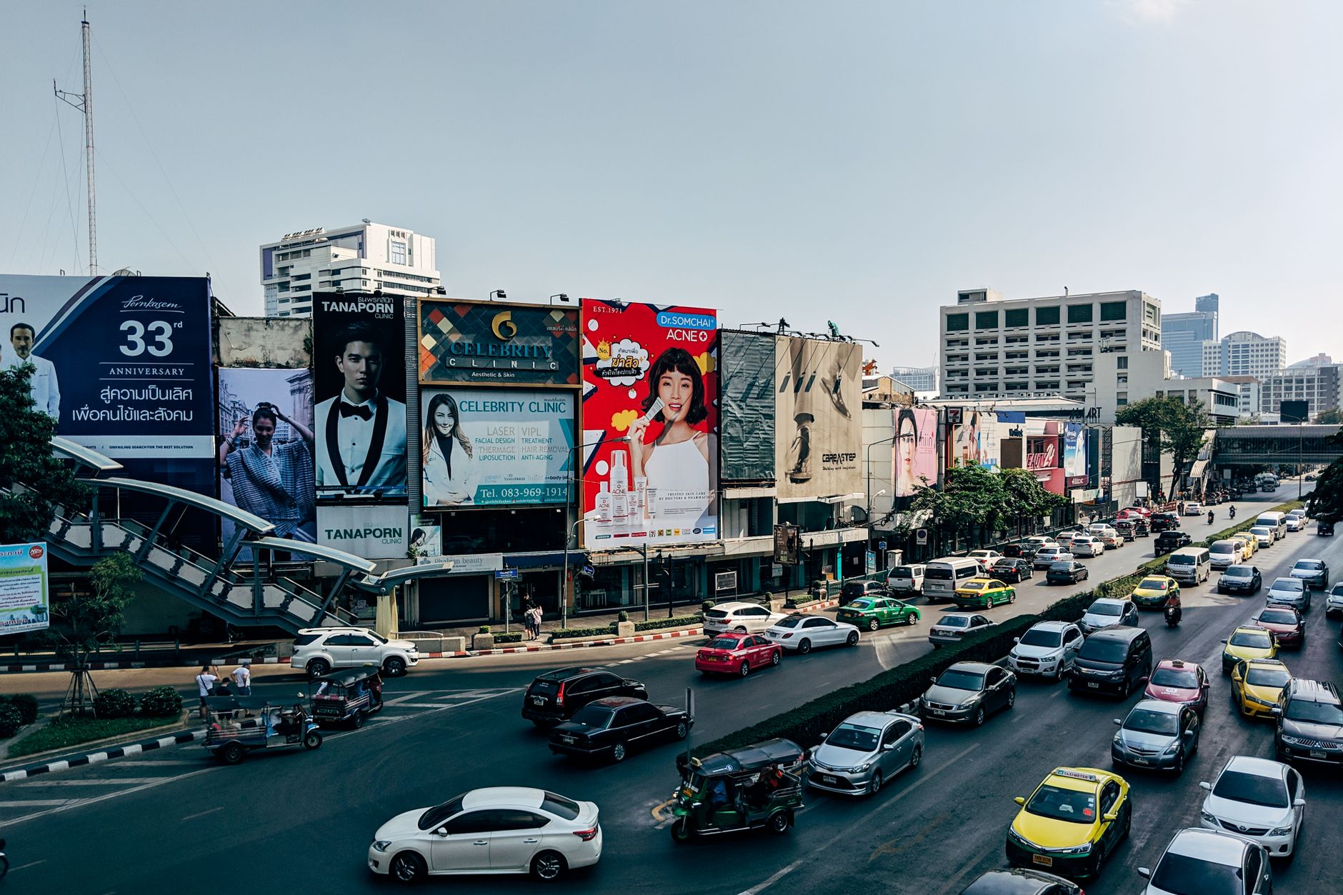 Dynamic cityscape of Bangkok showcasing heavy traffic and colorful billboards in the metropolis.